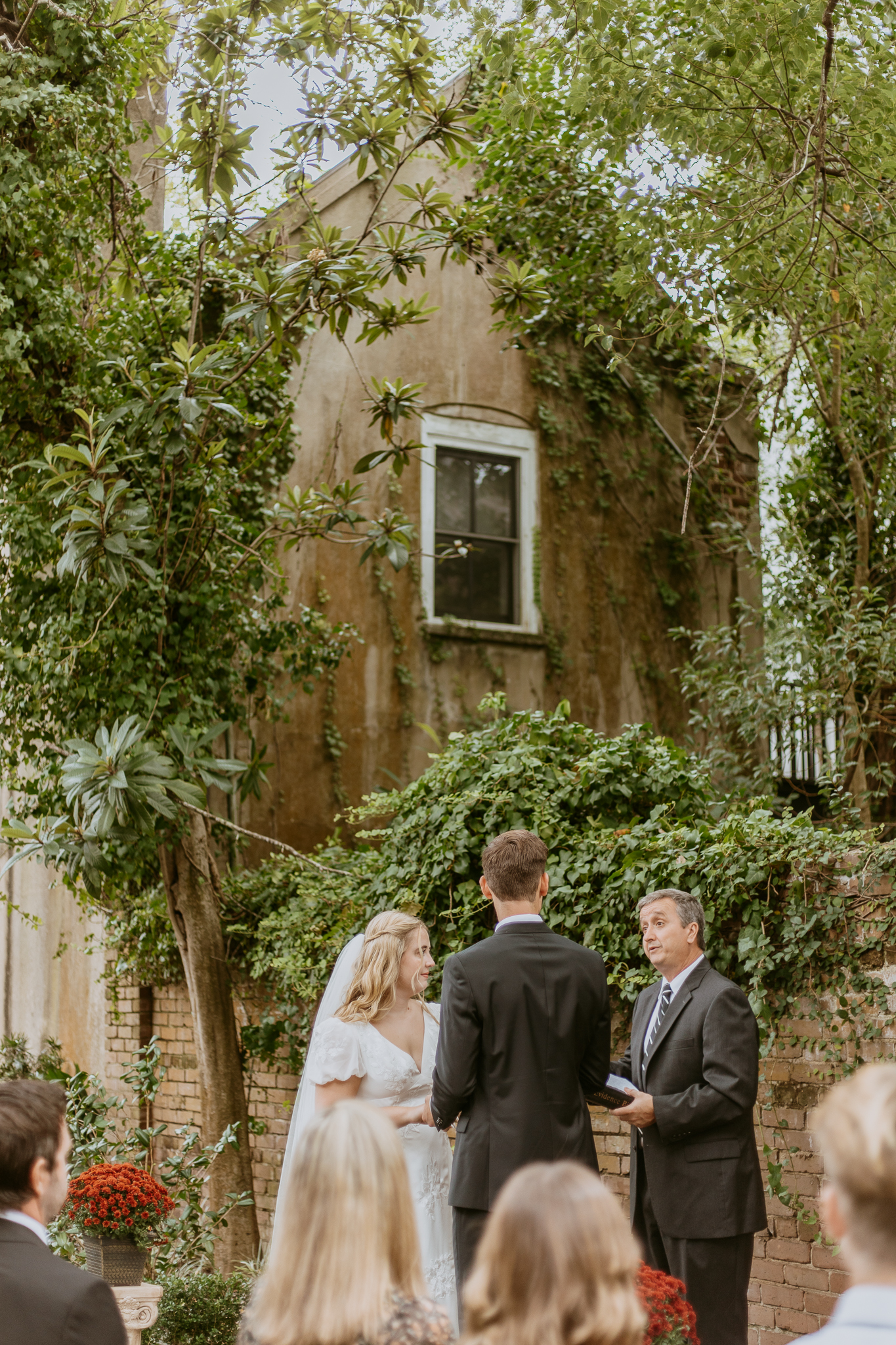 intimate charleston wedding ceremony in courtyard of historic home